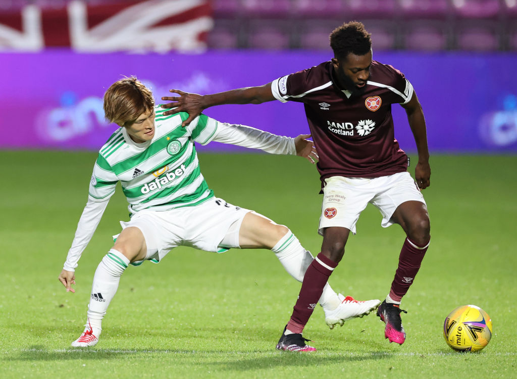 Kyogo Furuhashi of Celtic battles for possession with Beni Baningime of Heart of Midlothian during the Ladbrokes Scottish Premiership match between...