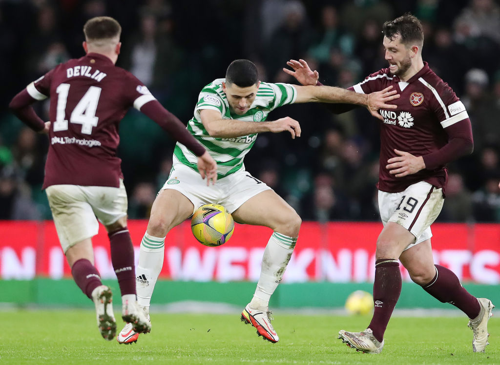 Tom Rogic of Celtic vies with Cameron Devlin and Craig Halkett of Hearts during the Cinch Scottish Premiership match between Celtic FC and Heart of...