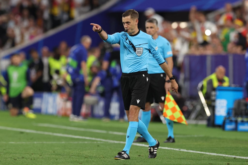 Referee Clement Turpin gestures following a VAR review to award a penalty to Germany after Ilkay Guendogan of Germany (not pictured) was fouled by ...
