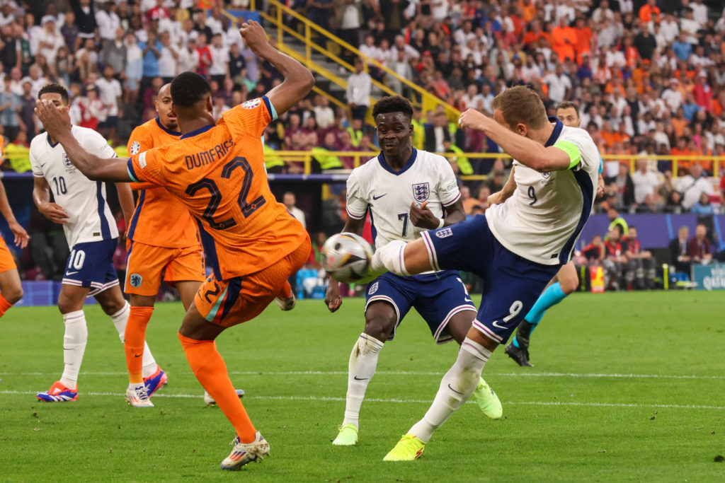 Denzel Dumfries of the Netherlands and Harry Kane of England battle for possession during the Semi-Final - UEFA EURO 2024 match between The Netherl...