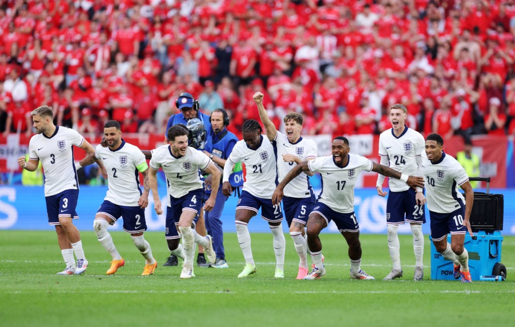 Players of England celebrate after Trent Alexander-Arnold of England (not pictured) scores the team's fifth and winning penalty in the penalty shoo...