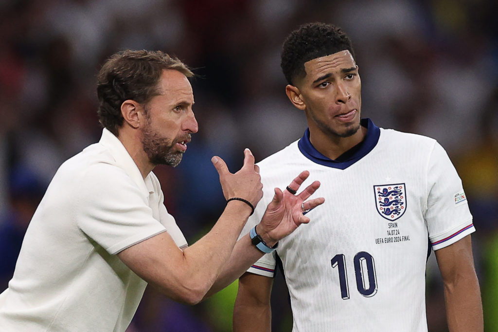 England's head coach Gareth Southgate speaks to England's midfielder #10 Jude Bellingham during the UEFA Euro 2024 final football match between Spa...