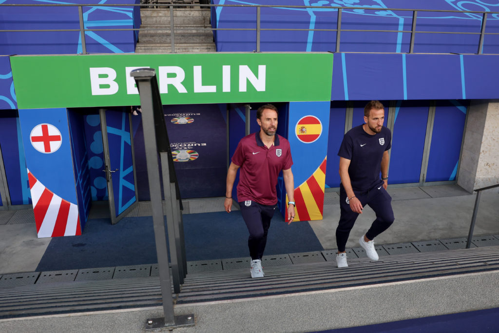 Gareth Southgate, Manager of England men's senior team, and Harry Kane of England walk out onto the pitch prior to the England Press Conference ahe...