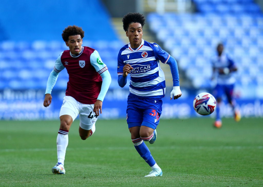 Andre Garcia of Reading chases a loose ball whilst under pressure from Junior Robinson of West Ham United during the Bristol Street Motors Trophy m...