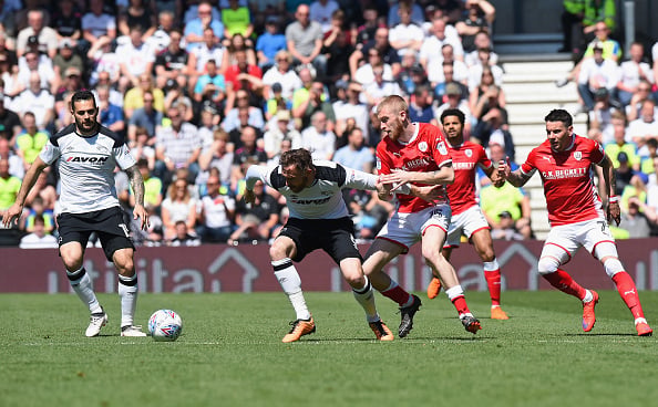 xxxx of Derby County is tackled by xxxx of Barnsley during the Sky Bet Championship match between Derby County and Barnsley at iPro Stadium on May ...