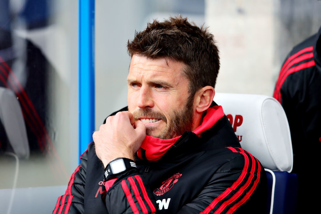 Assistant manager of Manchester United Michael Carrick looks on from the dugout during the Premier League match between Huddersfield Town and Manch...