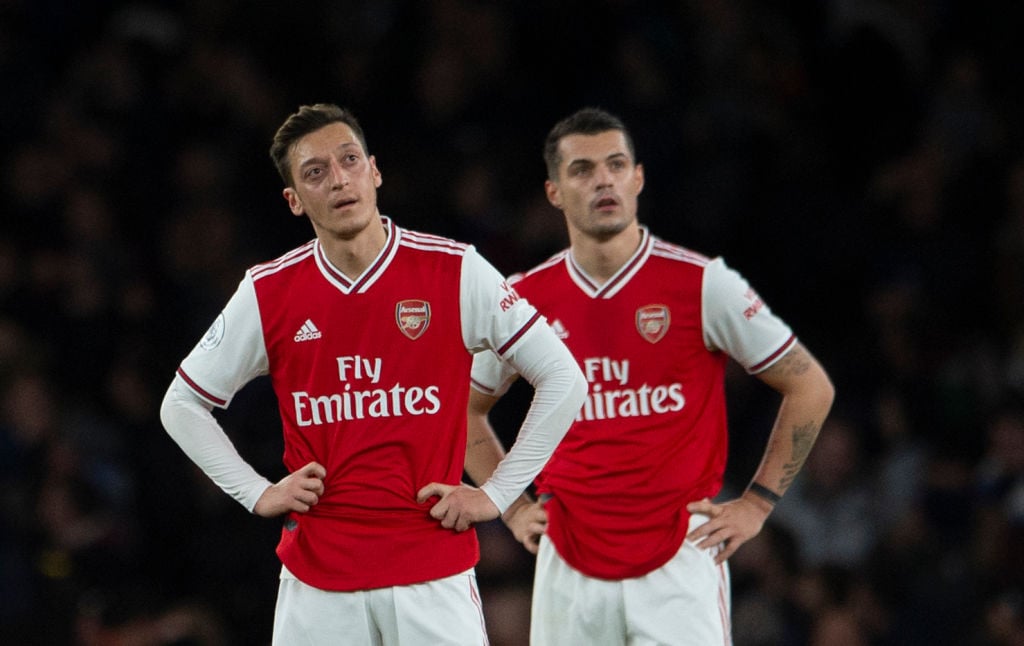 LONDON, ENGLAND - DECEMBER 05: A dejected Mesut Ozil and Granit Xhaka of Arsenal wait to kick off after Brighton and Hove Albion score their second...
