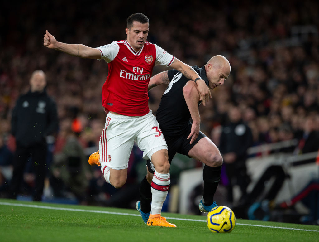 LONDON, ENGLAND - DECEMBER 05: Granit Xhaka of Arsenal and Aaron Mooy of Brighton and Hove Albion during to the Premier League match between Arsena...
