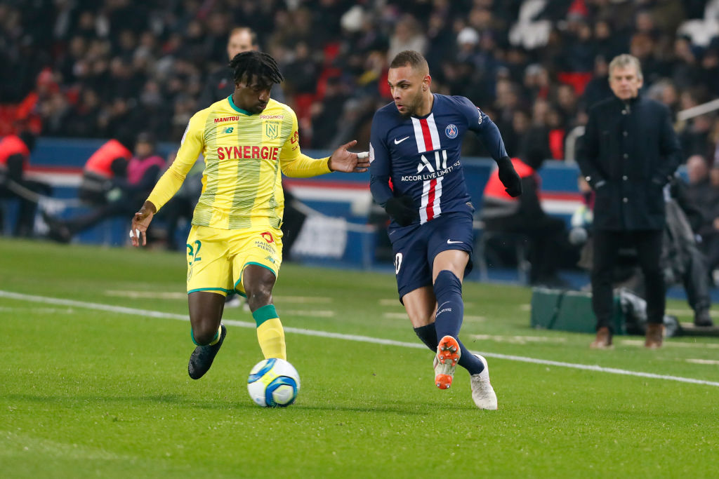 Layvin Kurzawa #20 of Paris Saint-Germain shoots the ball against Abdoul Kader Bamba #32 of FC Nantes during the Ligue 1 match between Paris Saint-...