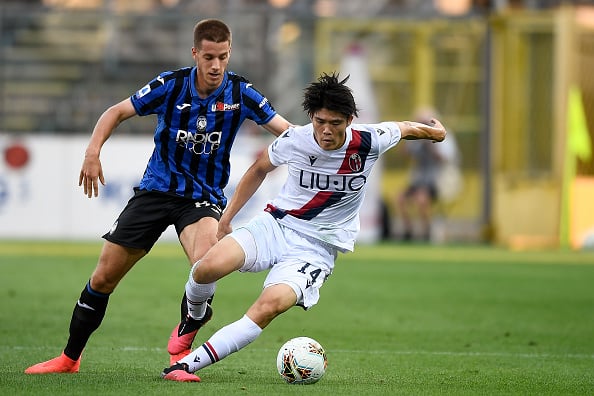 Takehiro Tomiyasu (R) of Bologna FC is challenged by Mario