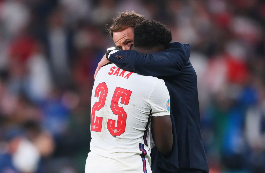 Bukayo Saka of England is consoled by Gareth Southgate, Head Coach of England following defeat in the UEFA Euro 2020 Championship Final between Ita...