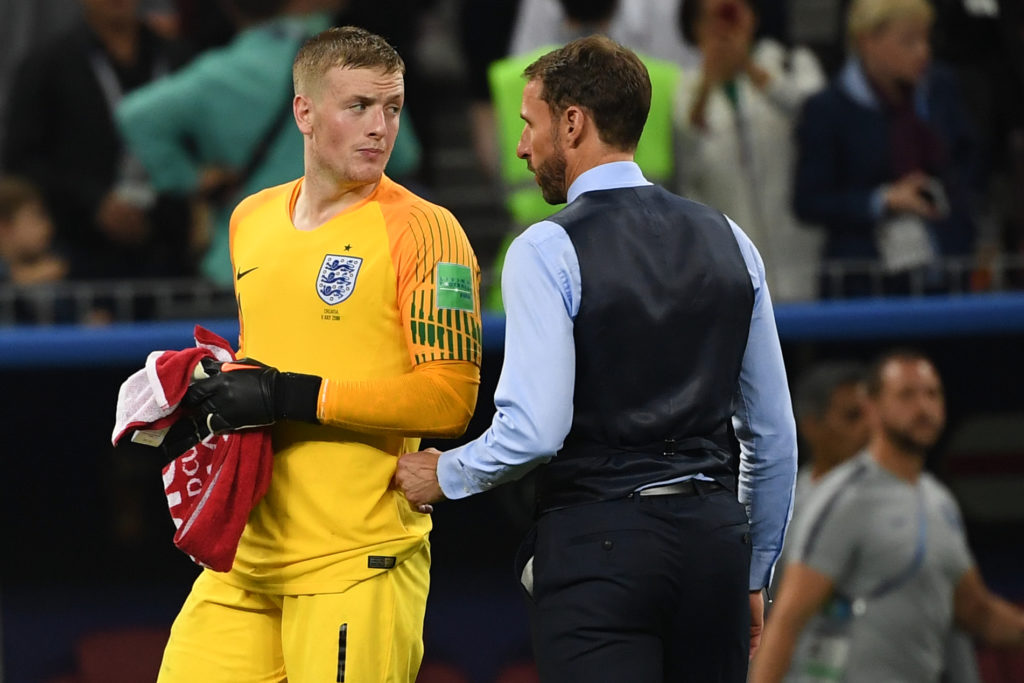 England's coach Gareth Southgate (R) speaks with England's goalkeeper Jordan Pickford during the Russia 2018 World Cup semi-final football match be...