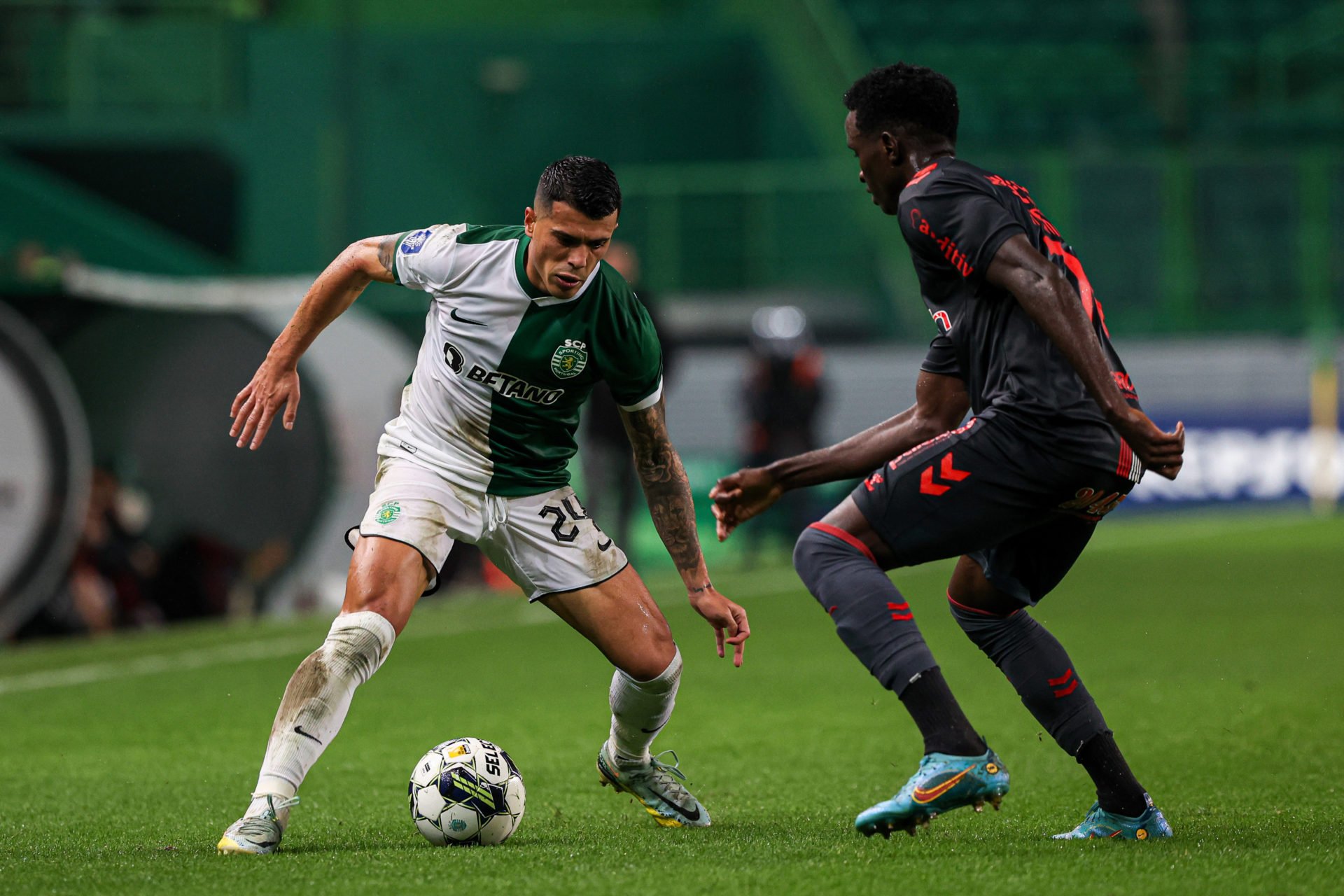 Pedro Porro (L) of Sporting CP seen in action during the...