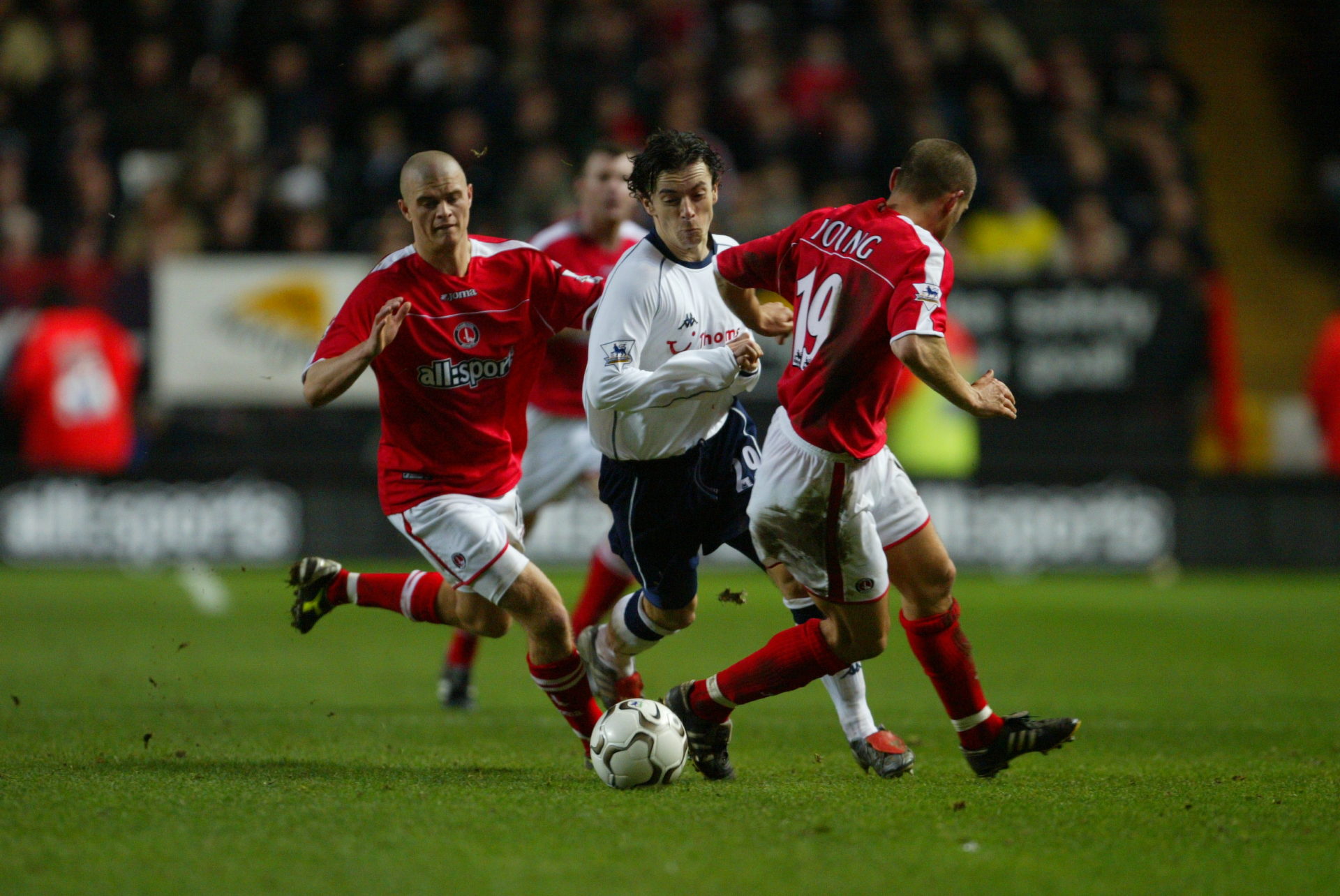 Simon Davies of Tottenham Hotspur and Paul Konchesky and Luke Young of Charlton Athletic