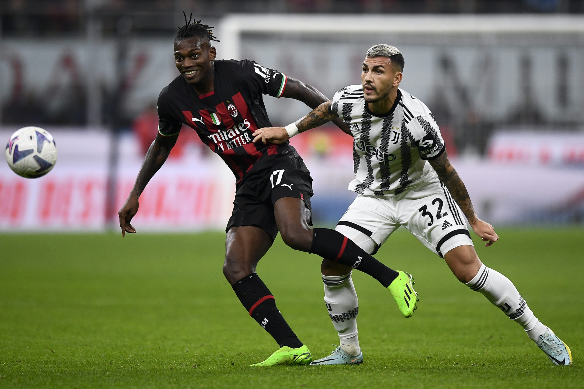 Rafael Leao (L) of AC Milan competes for the ball with