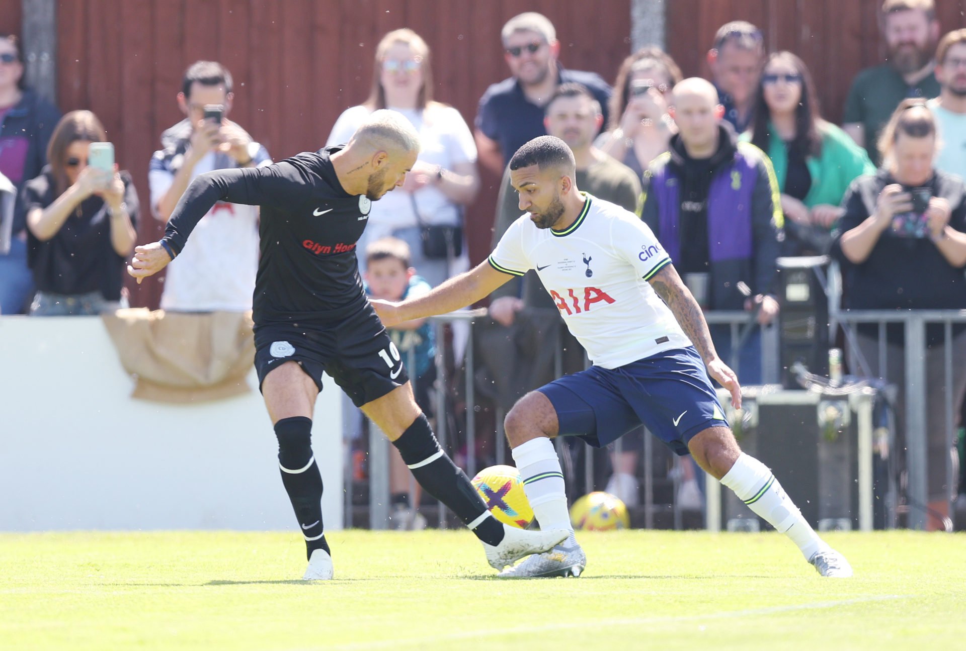  Former Tottenham Hotspur player Aaron Lennon takes the ball past an opposition player during a charity match.