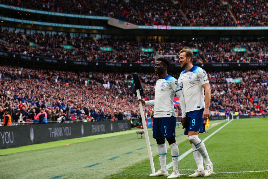 England forwards Harry Kane and Bukayo Saka celebrate scoring vs Ukraine in UEFA EURO 2024 qualifier game