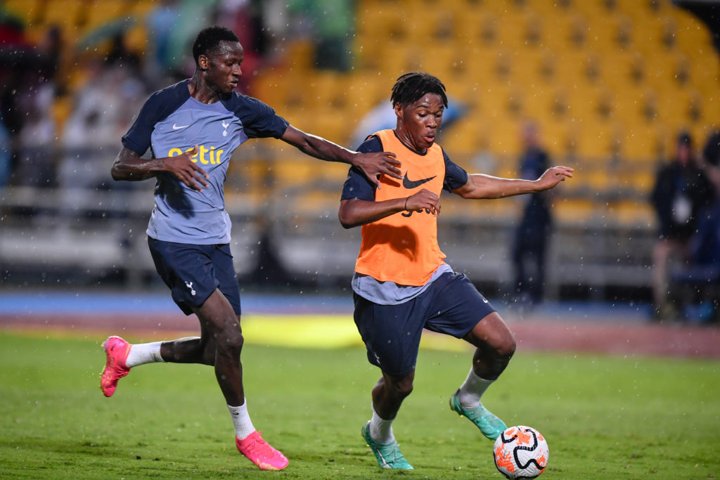 Destiny Udogie (R) and Pape Matar Sarr of Tottenham Hotspur...