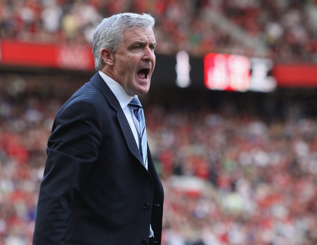 Manager Mark Hughes of Manchester City complains to the fourth official during the FA Barclays Premier League match between Manchester United and M...