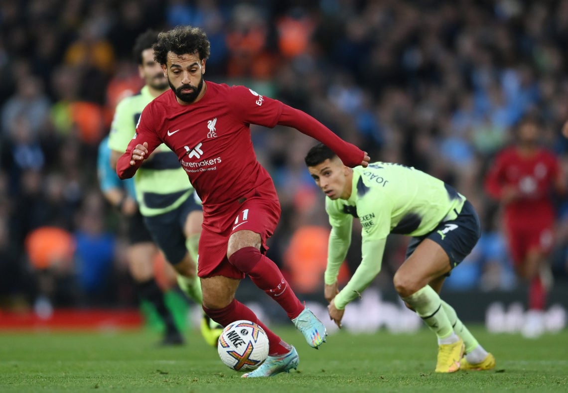 Mohamed Salah of Liverpool gets away from Joao Cancelo of Manchester City to go on and score their side's first goal during the Premier League matc...