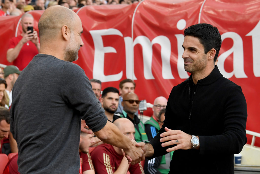 Pep Guardiola, Manager of Manchester City, interacts with Mikel Arteta, Manager of Arsenal, prior to the Premier League match between Arsenal FC an...