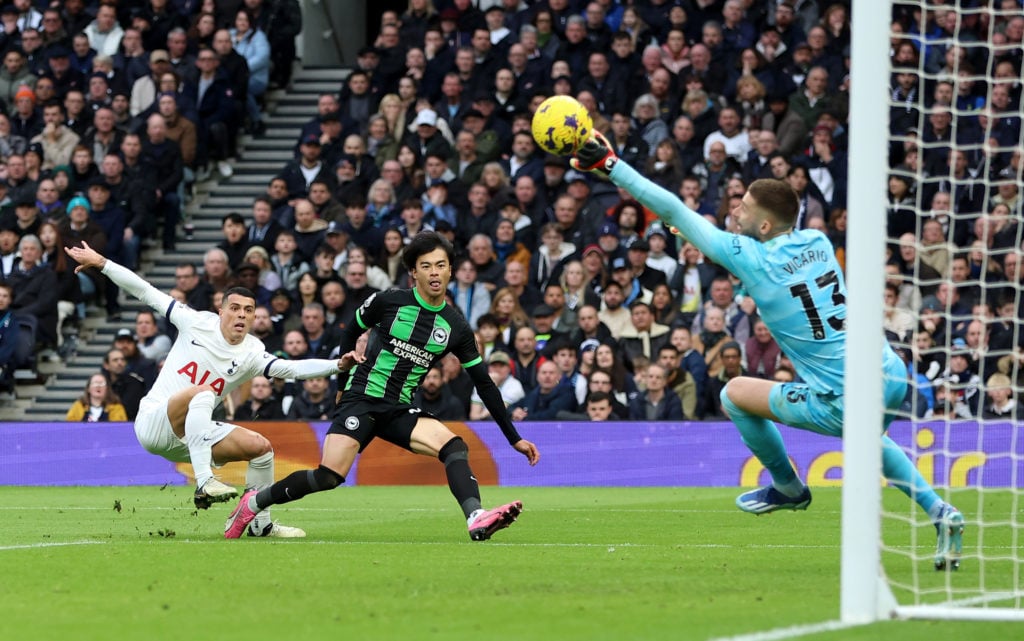 Kaoru Mitoma of Brighton & Hove Albion has a shot saved by Guglielmo Vicario of Tottenham Hotspur during the Premier League match between Totte...