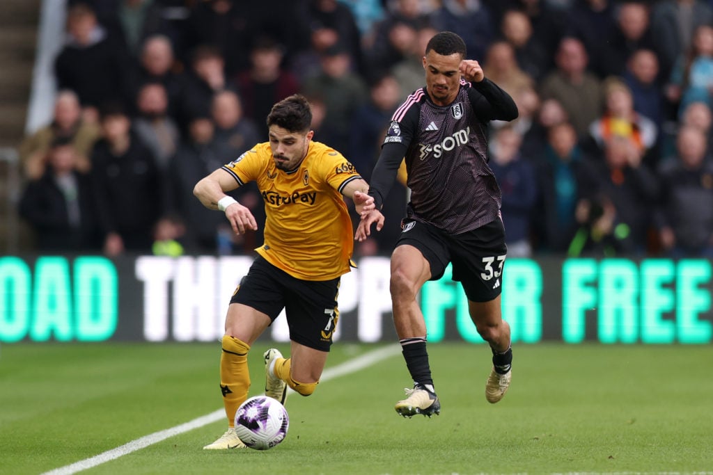 Pedro Neto of Wolverhampton Wanderers runs with the ball whilst under pressure from Antonee Robinson of Fulham during the Premier League match betw...