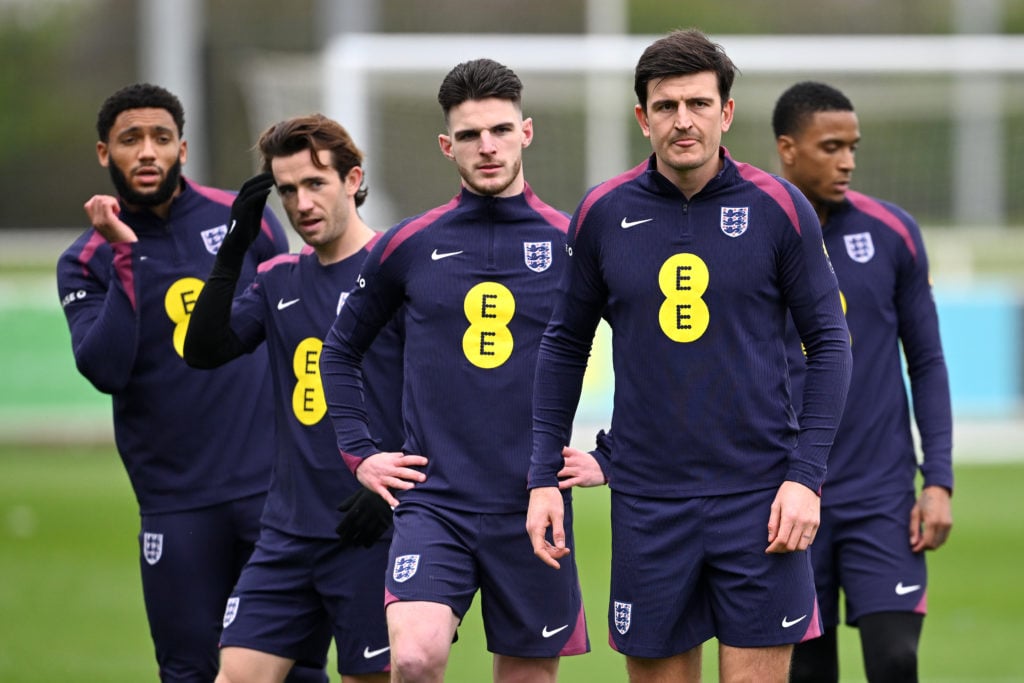 Joe Gomez, Ben Chilwell, Declan Rice and Harry Maguire of England look on during a training session at St Georges Park on March 20, 2024 in Burton-...