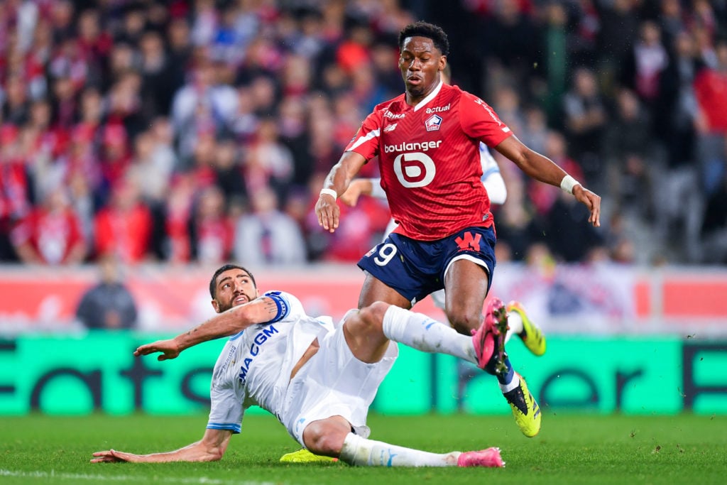 Jonathan David of Lille OSC competes for the ball with Samuel Gigot of Olympique de Marseille during the Ligue 1 Uber Eats match between Lille OSC ...