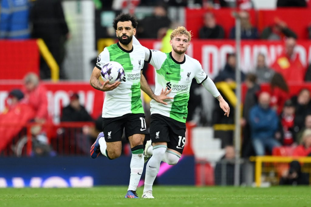 Mohamed Salah of Liverpool (L) celebrates scoring his team's second goal from the penalty spot with teammate Harvey Elliott during the Premier Leag...