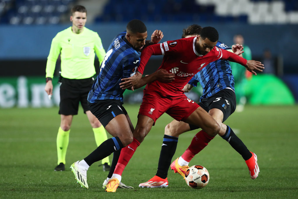 Cody Gakpo of Liverpool is challenged by Isak Hien and Berat Djimsiti of Atalanta BC during the UEFA Europa League 2023/24 Quarter-Final second leg...