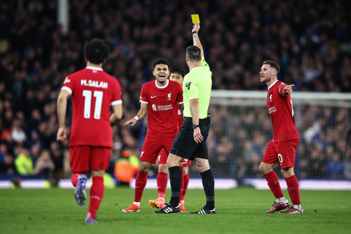 Referee Andrew Madley shows Luis Diaz of Liverpool a yellow card during the Premier League match between Everton FC and Liverpool FC at Goodison Pa...