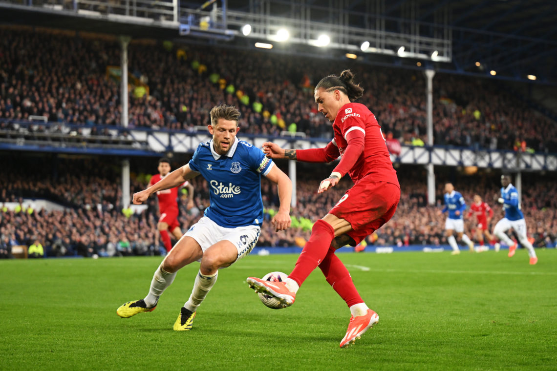 Darwin Nunez of Liverpool controls the ball whilst under pressure from James Tarkowski of Everton during the Premier League match between Everton F...