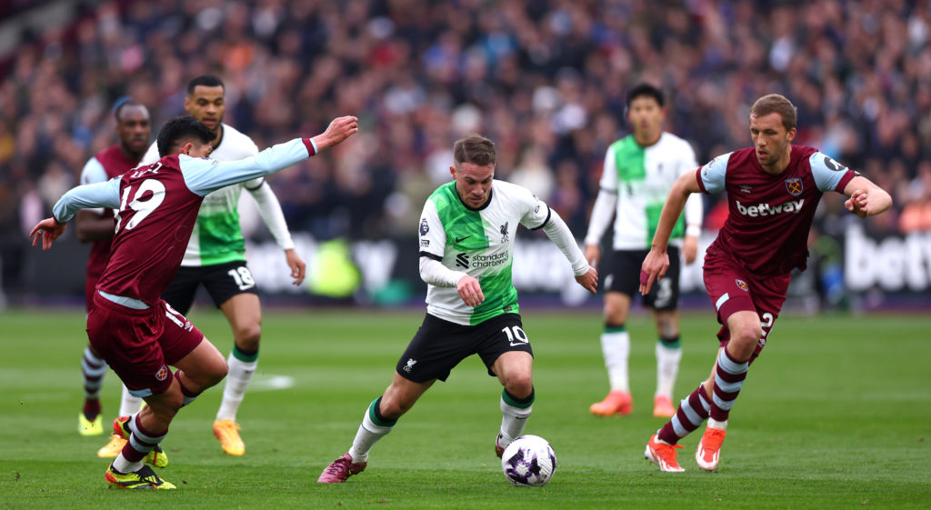 Alexis Mac Allister of Liverpool controls the ball under pressure of Tomas Soucek and Edson Alvarez of West Ham United during the Premier League ma...