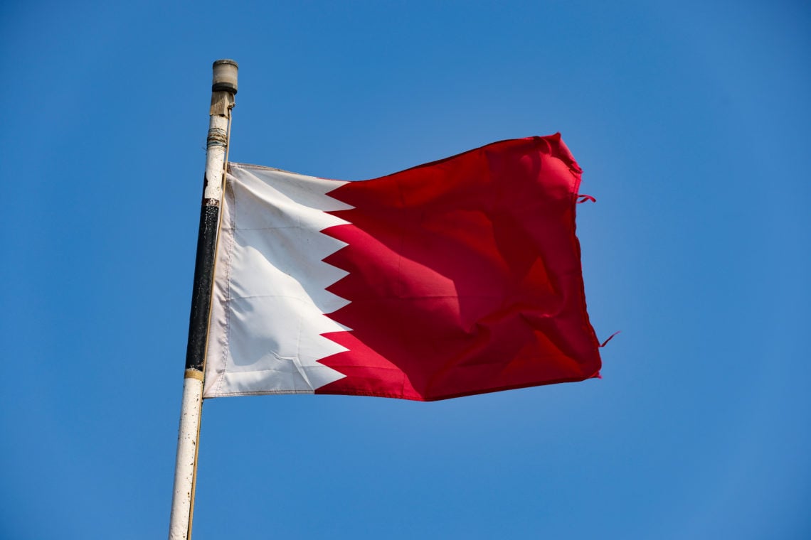 The national flag of Qatar - the host venue for the Qatar 2022 FIFA World Cup on October 8, 2020 in the old Doha Port, Qatar.