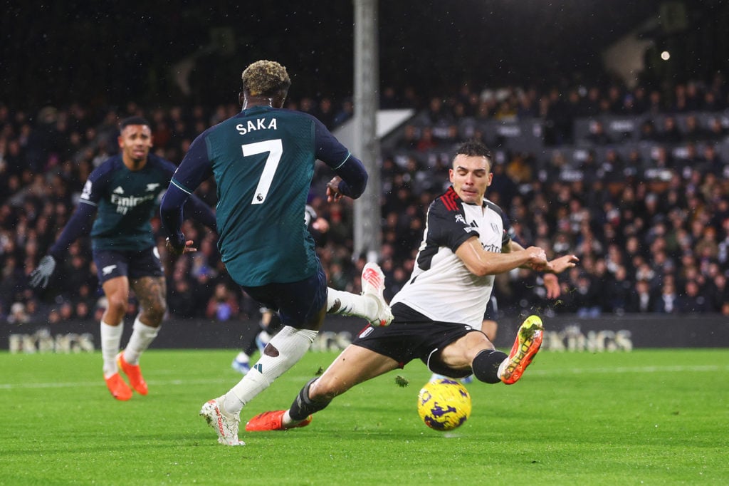 Joao Palhinha of Fulham blocks a shot from Bukayo Saka of Arsenal during the Premier League match between Fulham FC and Arsenal FC at Craven Cottag...