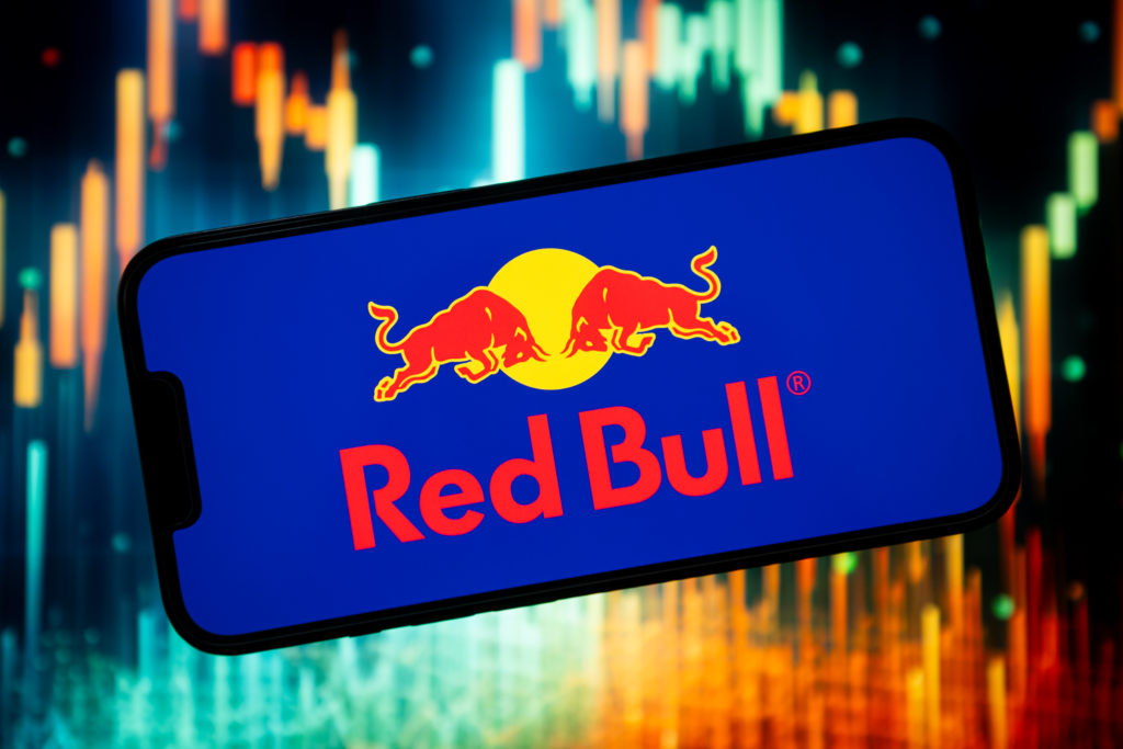 In this photo illustration a Red Bull logo seen displayed on