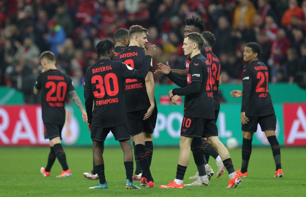 Florian Wirtz of Bayer 04 Leverkusen celebrates with teammates after scoring his teams third goal during the DFB cup semifinal match between Bayer ...