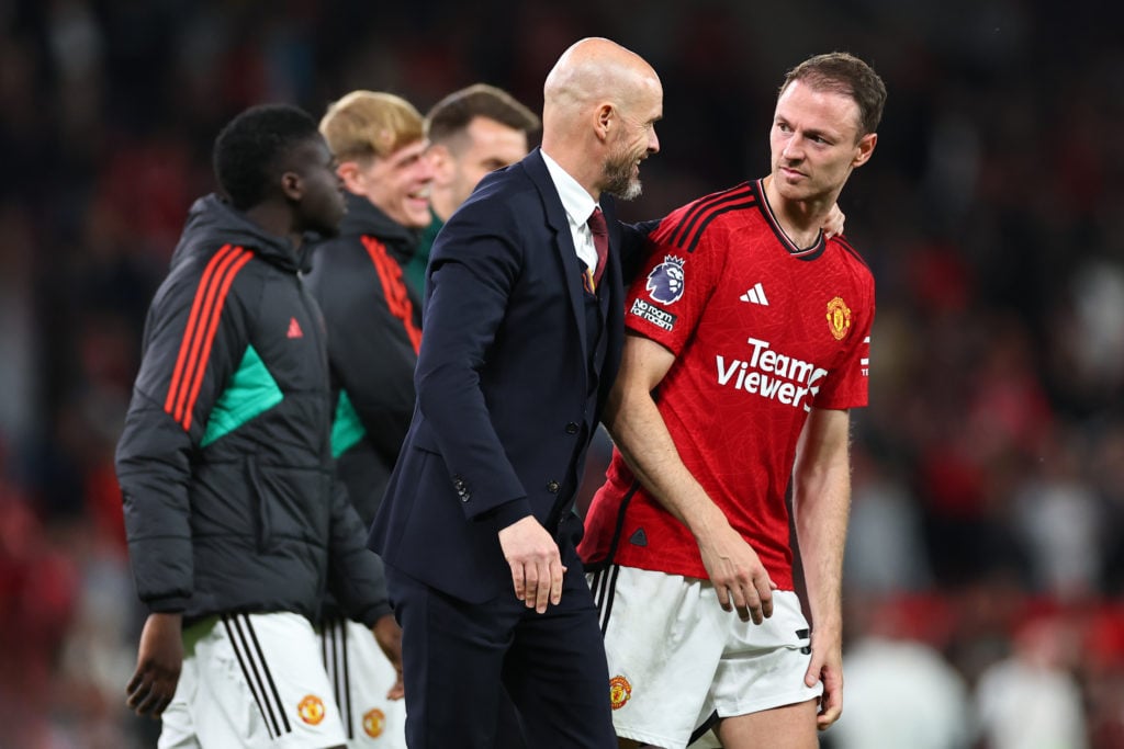 Erik ten Hag the head coach / manager of Manchester United at full time with Jonny Evans during the Premier League match between Manchester United...