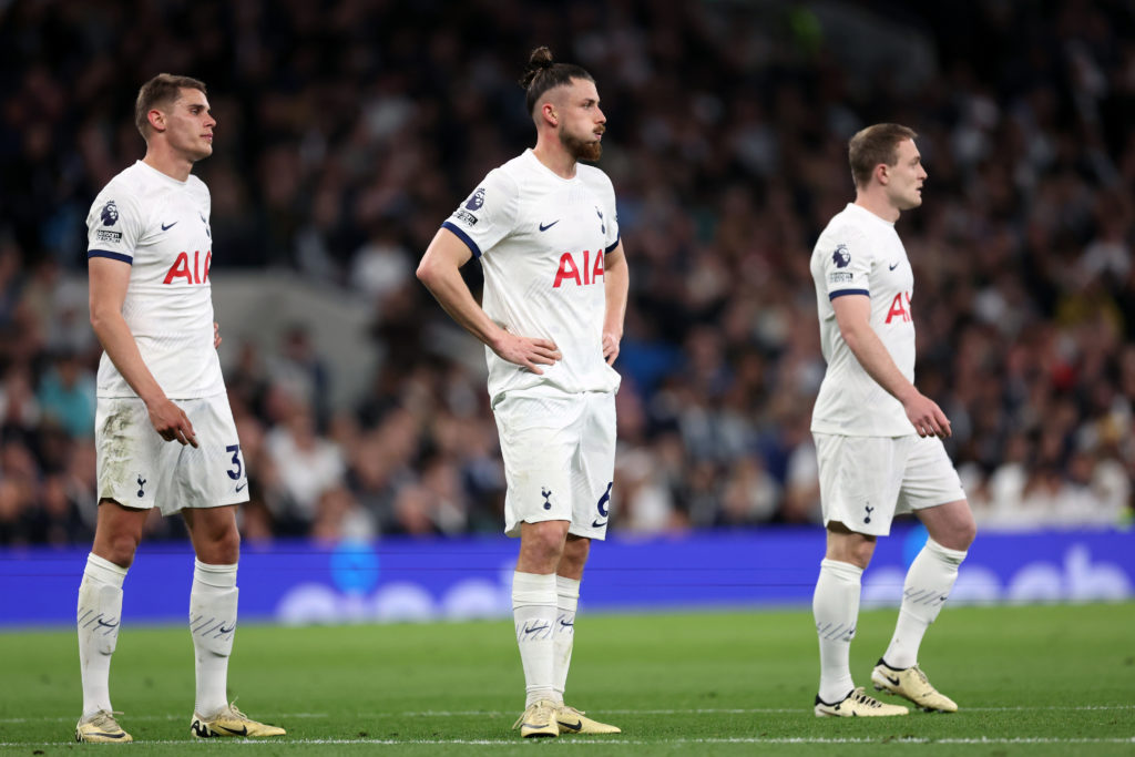 Radu Dragusin of Tottenham Hotspur reacts as he stands with Micky van de Ven and Oliver Skipp of Tottenham Hotspur during the Premier League match ...