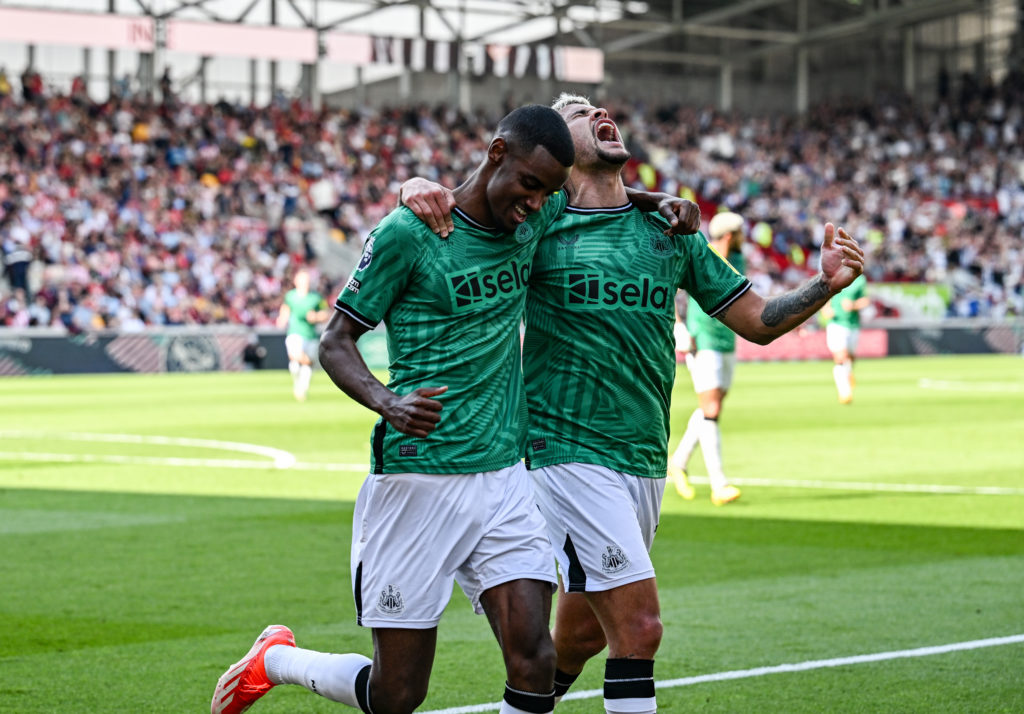 Alexander Isak of Newcastle United (14) celebrates with teammate Bruno Guimaraes after scoring the third goal during the Premier League match betwe...