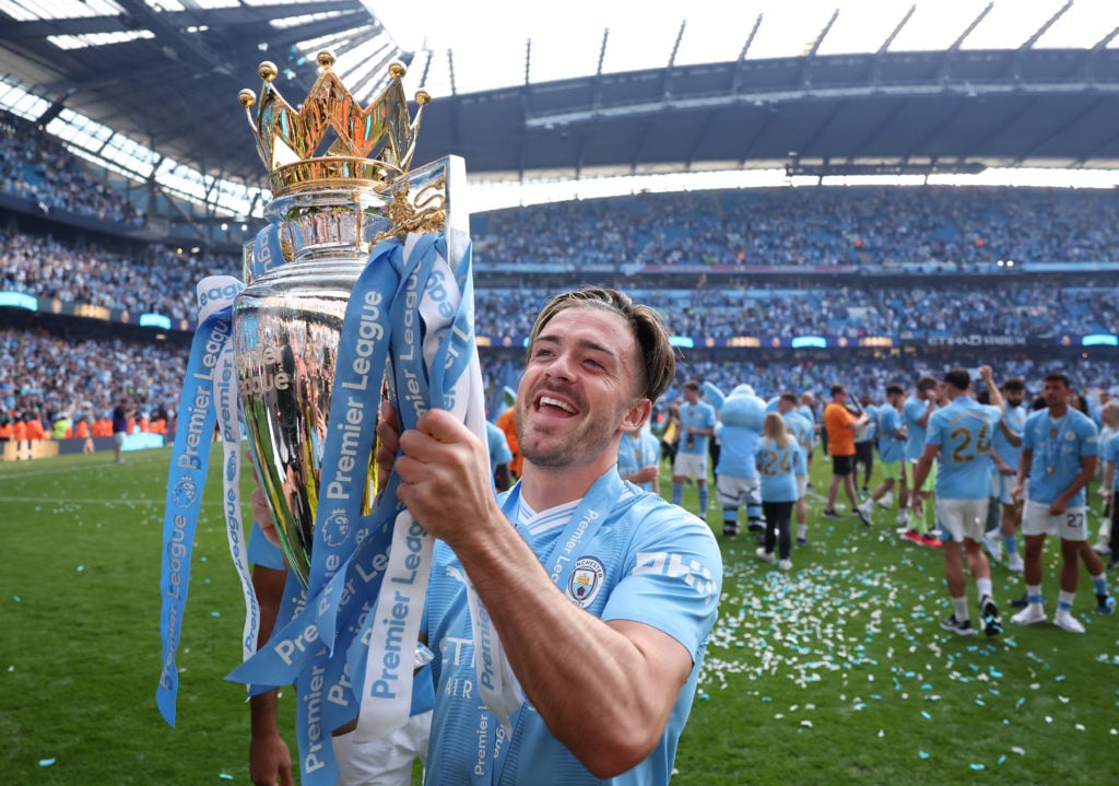 Jack Grealish of Manchester City poses with the Premier League trophy after the Premier League match between Manchester City and West Ham United at...