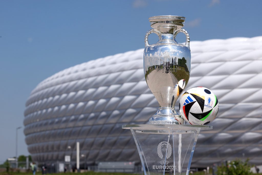 The UEFA EURO 2024 Winners Trophy is pictured with the official adidas matchball Fußballliebe in front of the Allianz Arena during the UEFA Euro 20...