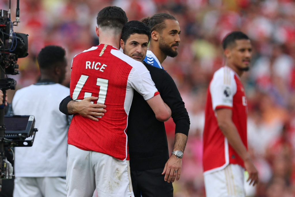 Arsenal's Spanish manager Mikel Arteta (C) consoles Arsenal's English midfielder #41 Declan Rice (L) on the pitch after the English Premier League ...