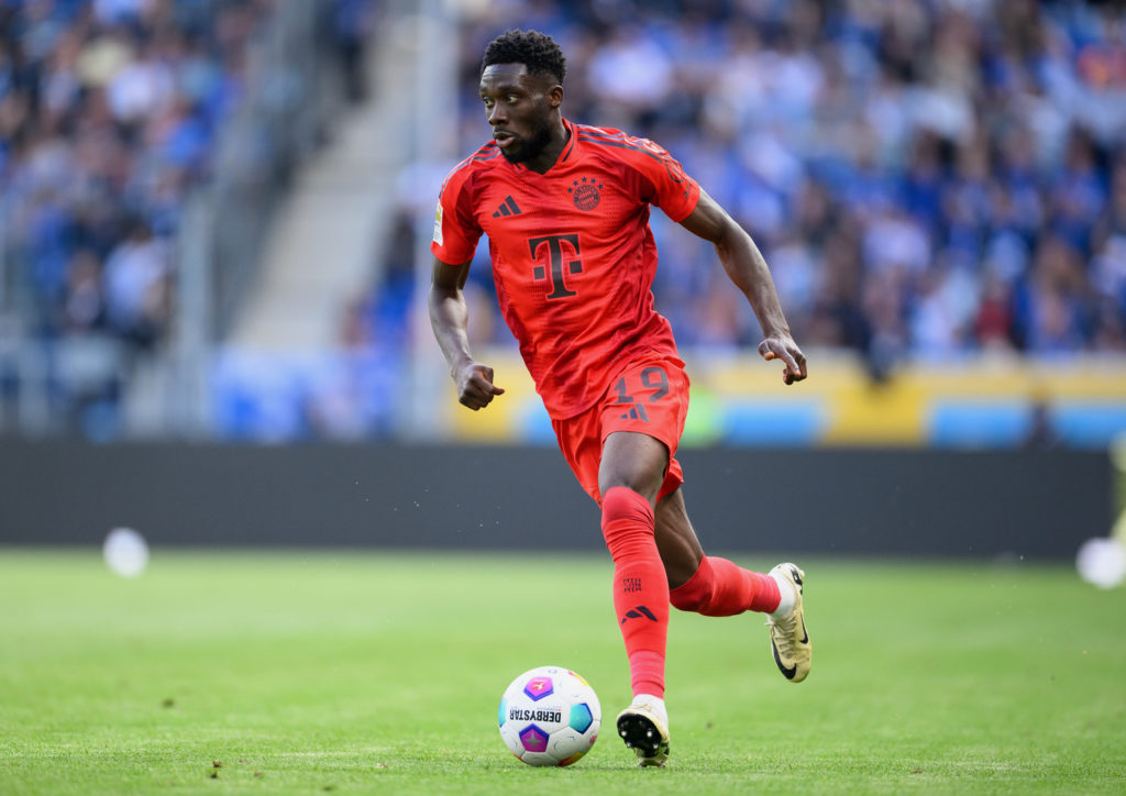 Alphonso Davies of Bayern Munich controls the ball during the Bundesliga match between TSG Hoffenheim and FC Bayern München at PreZero-Arena on May...