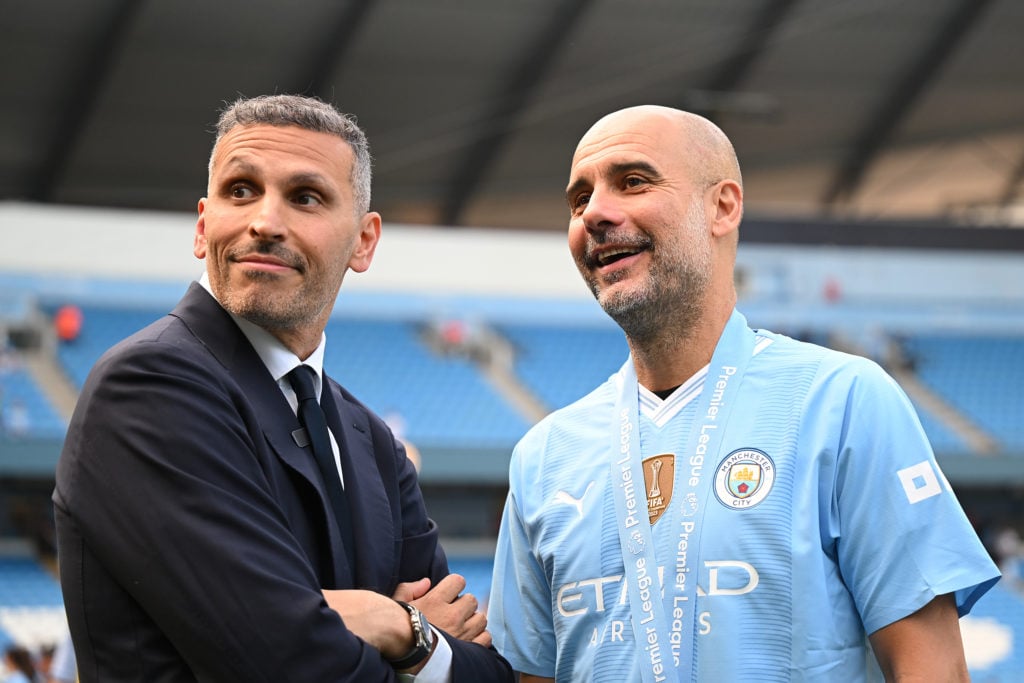 Khaldoon Al Mubarak, Chairman of Manchester City, and Pep Guardiola, Manager of Manchester City, watch on following the team's victory in the Premi...