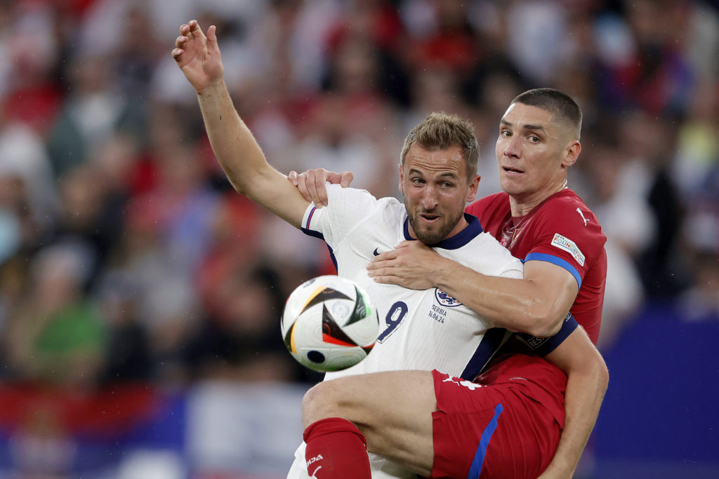 (L-R) Harry Kane of England, Nikola Milenkovic of Serbia  during the  EURO match between Serbia  v England at the Veltins Arena on June 16, 2024 in...