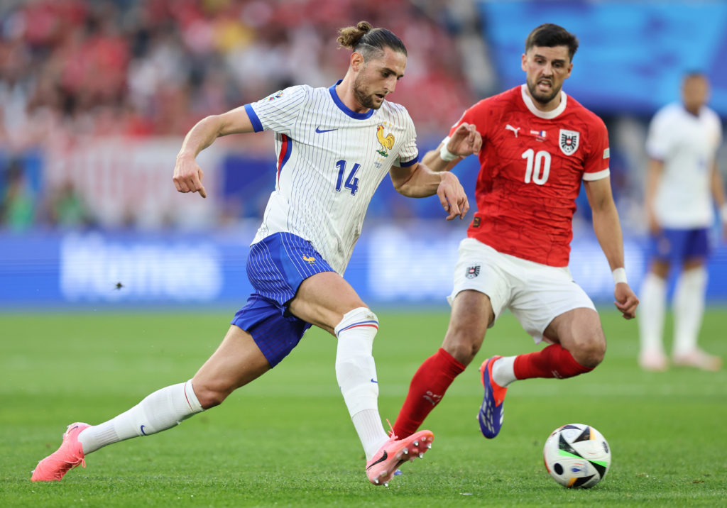 Adrien Rabiot of France runs with the ball whilst under pressure from Florian Grillitsch of Austria during the UEFA EURO 2024 group stage match bet...