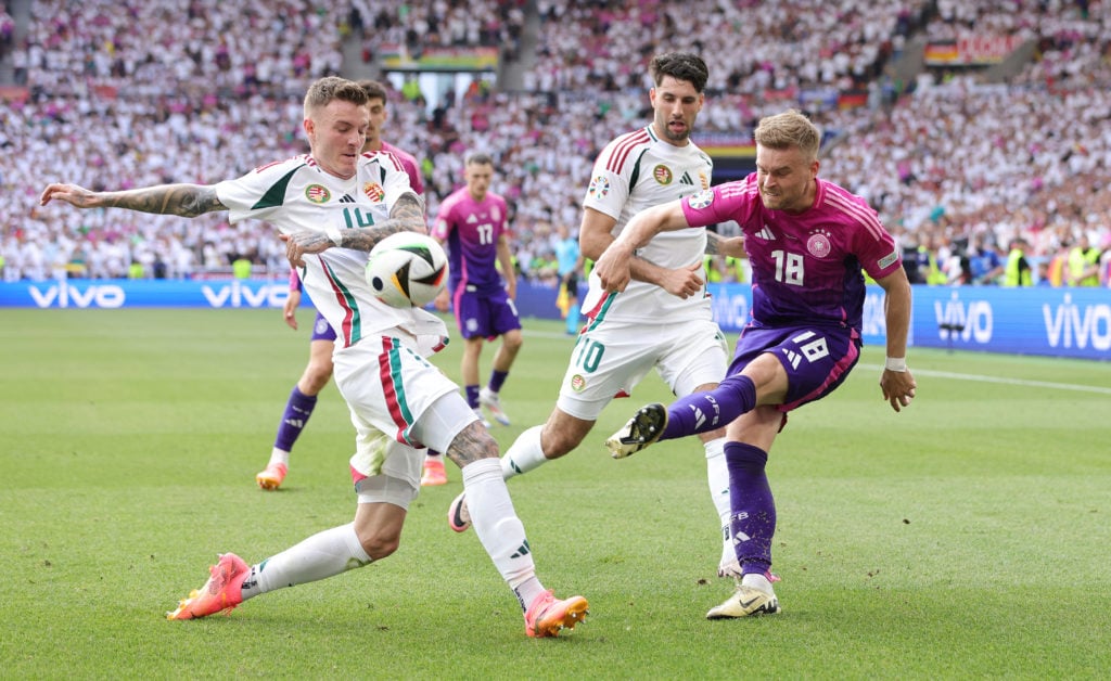 Maximilian Mittelstädt of Germany (R) and Bendeguz Bolla of Hungary compete for the ball during the UEFA EURO 2024 group stage match between German...