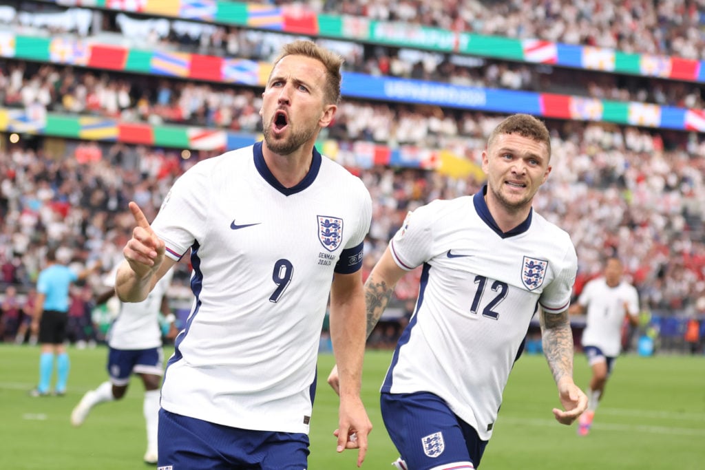 Harry Kane of England celebrates scoring the opening goal with Kieran Trippier during the UEFA EURO 2024 group stage match between Denmark and Engl...
